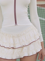 Sporty White Top With Red Zipper Details And A Matching Ruffled Skirt Set