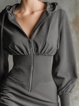 Stylish Gray Hooded Sweatshirt With Zippered Waist And Elasticated Hem Paired With A Midi Dress