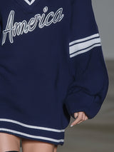 Stylish Blue Knitted Mini Dress With White Embroidery And Contrasting Panels.